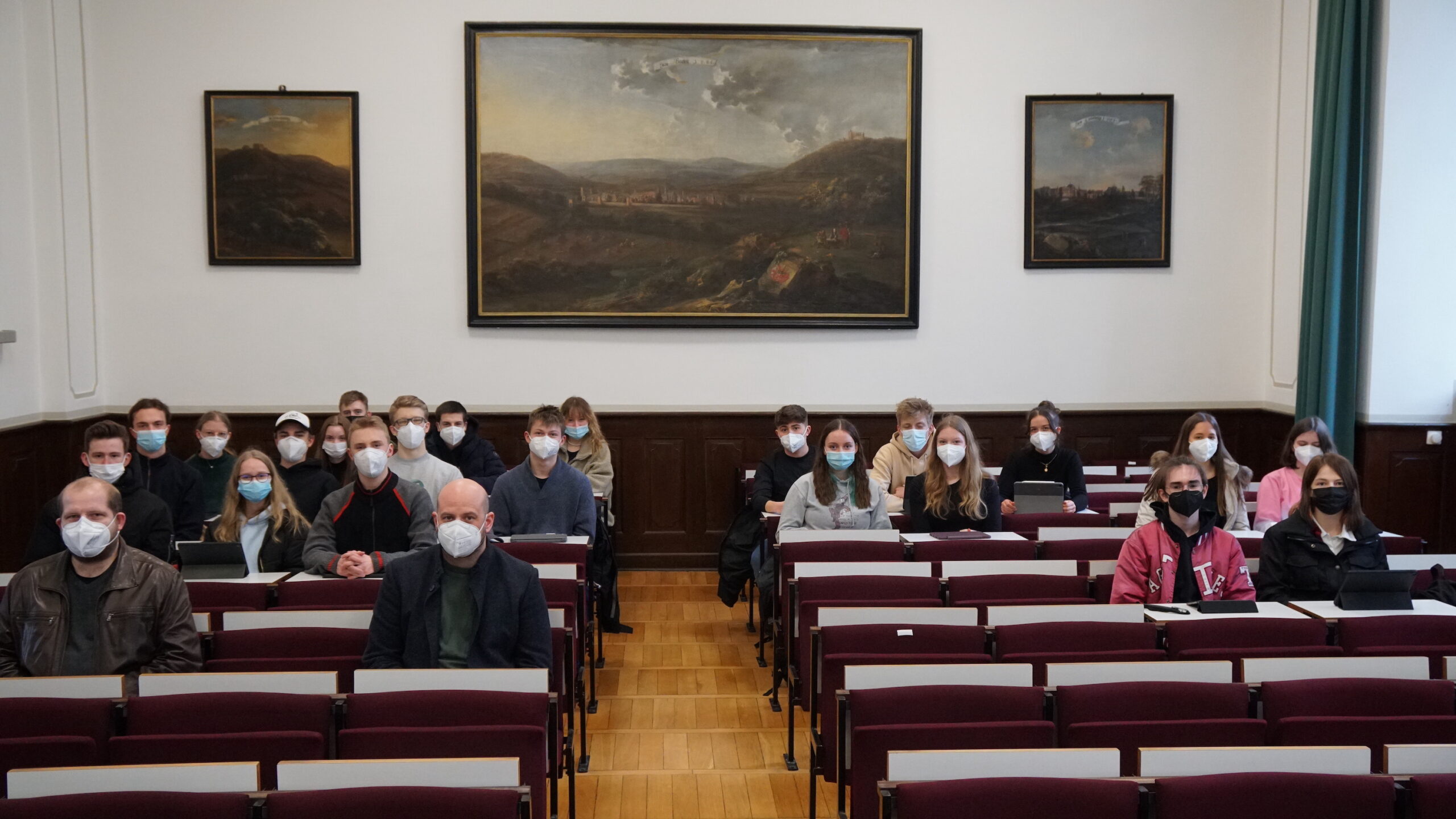Menschen mit Maske in einem Hörsaal